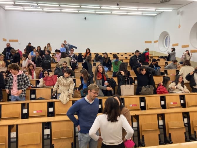 Estudiantes en un auditorio universitario durante una charla